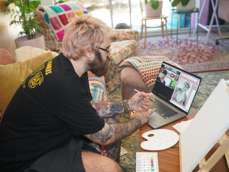 Man does online painting class at home for Valentine's weekend