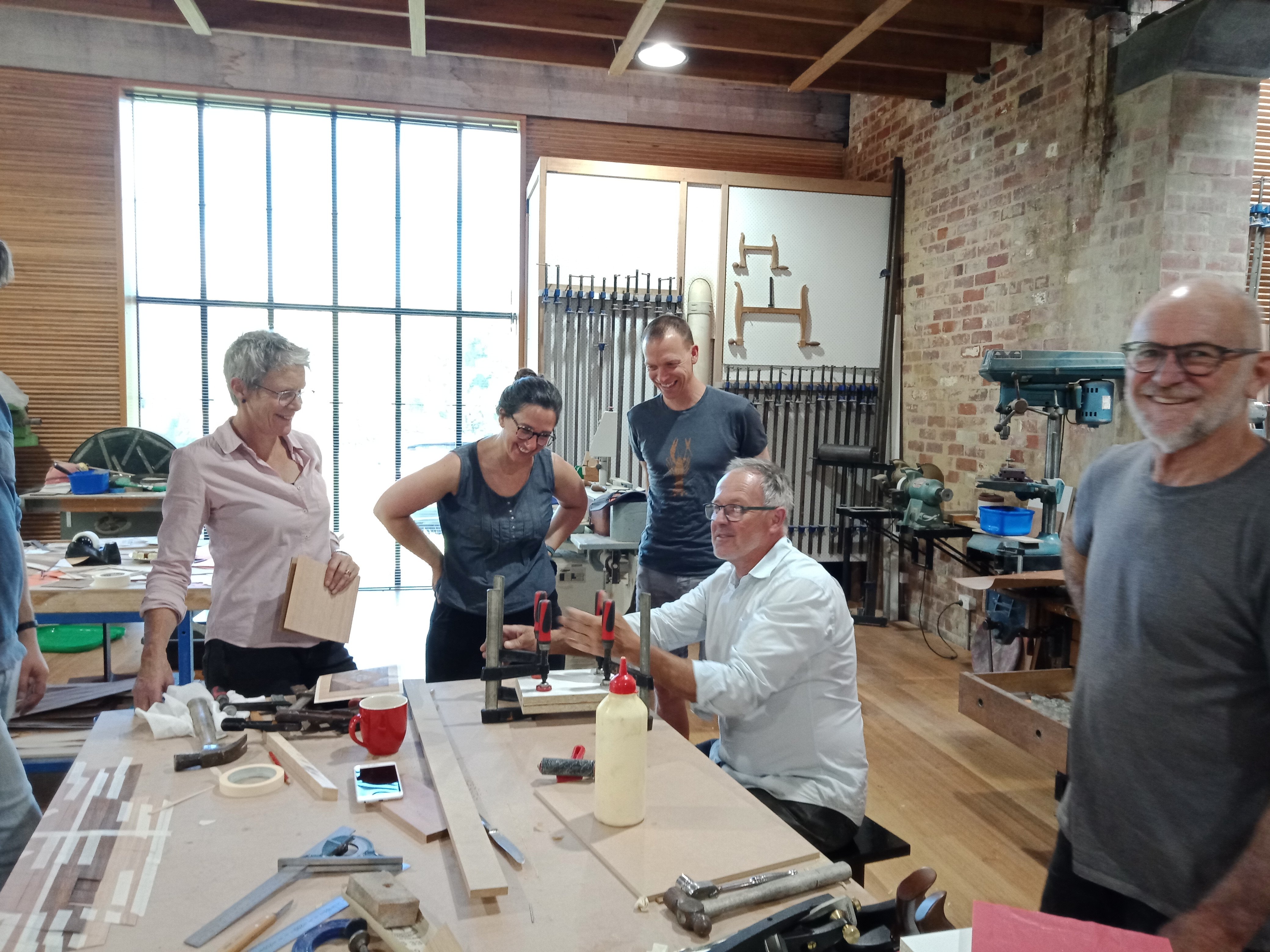 People enjoying a woodworking class