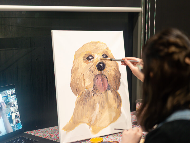Woman painting a dog