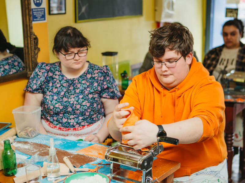 Couple making pasta at a cooking class for couples