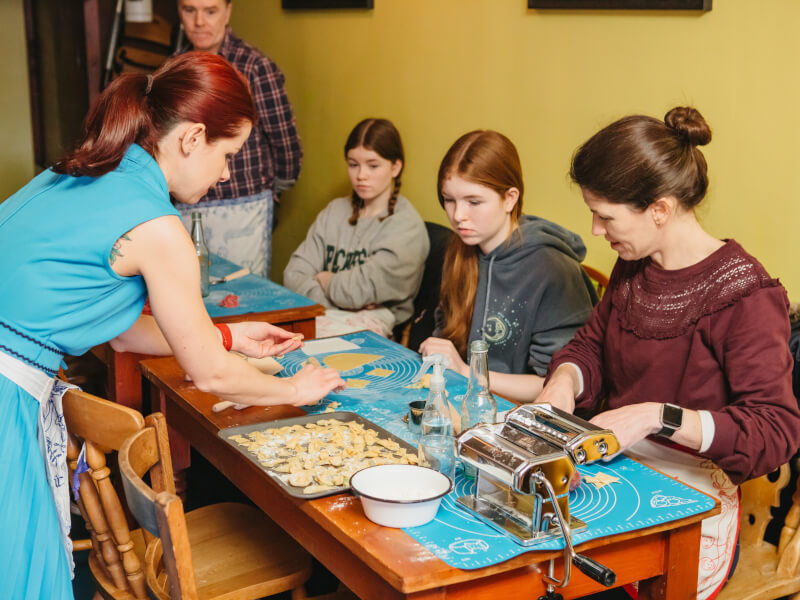 A family of four make pasta at a cooking class