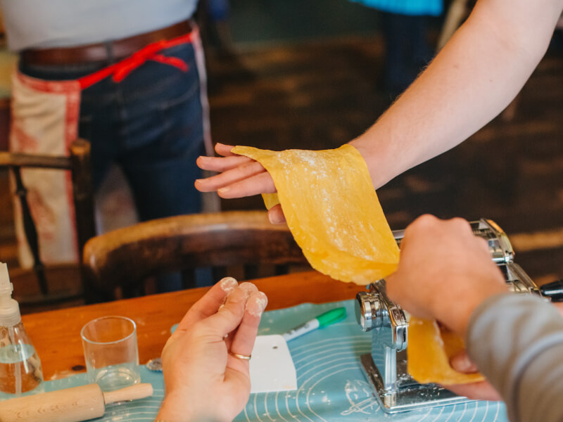 Depiction of couples hands making pasta
