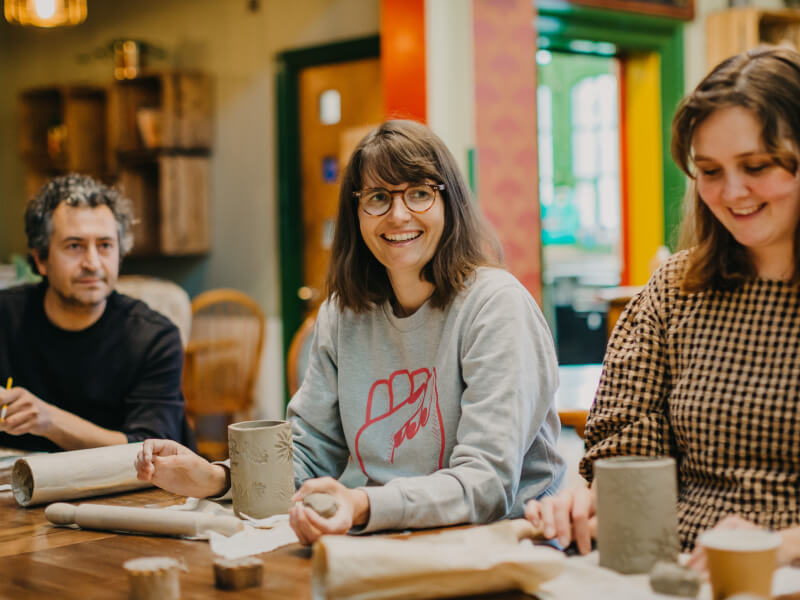 A group of colleagues celebrate the end of year with pottery
