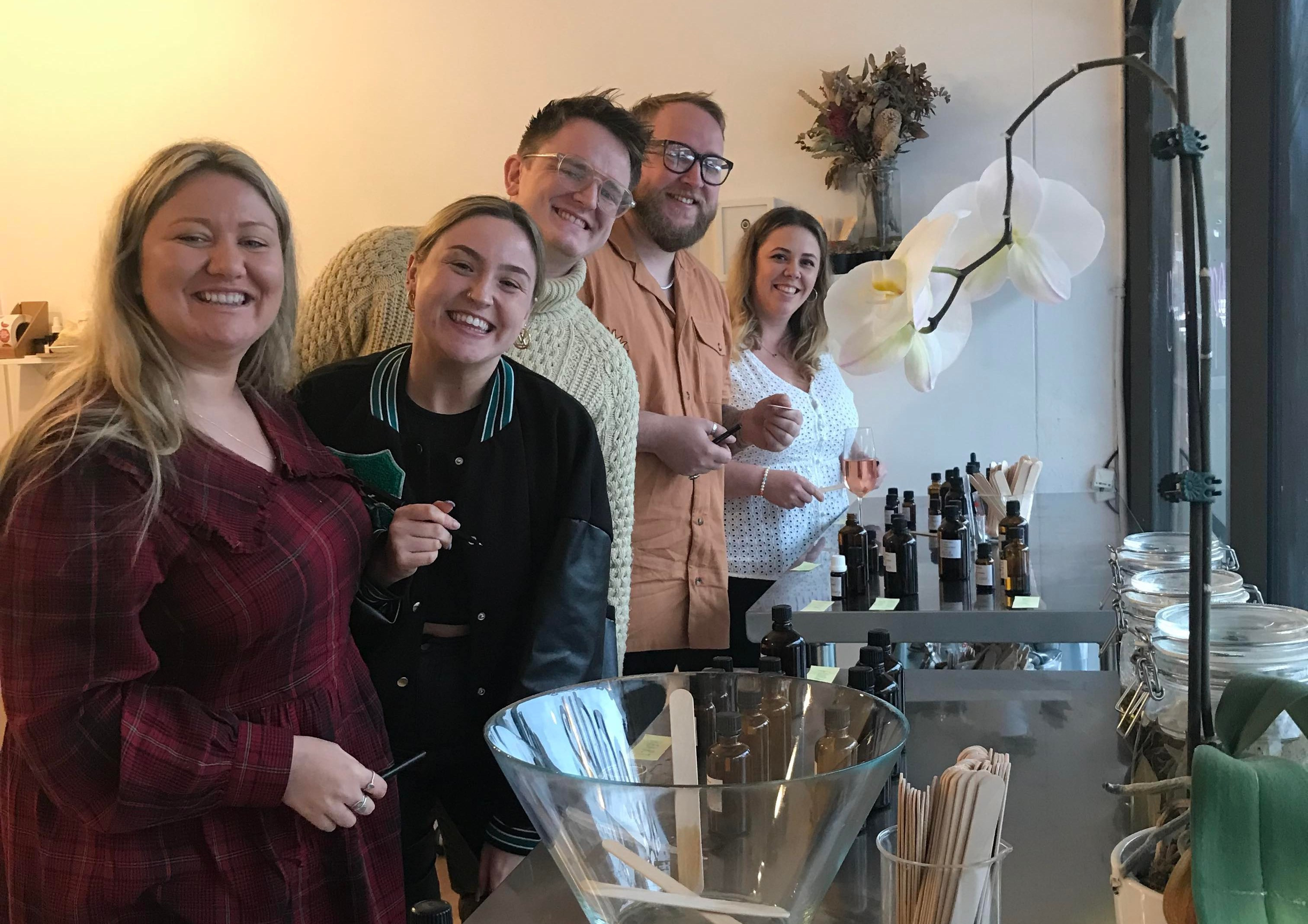 A happy family enjoying a perfume making class