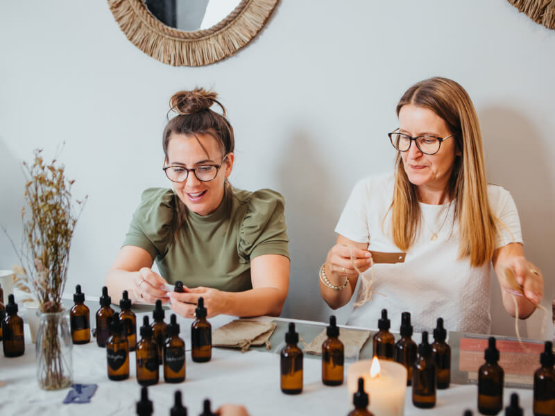 Two women enjoying a perfume making class