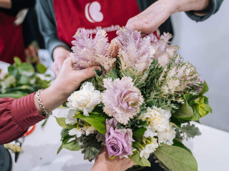Person touching a flower arrangement