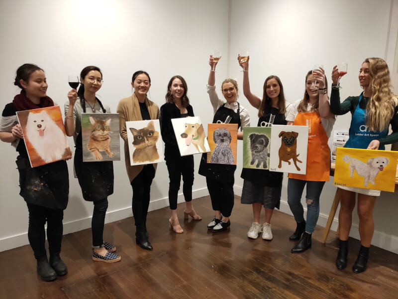 Birthday group with their finished pet portraits at a paint and sip class