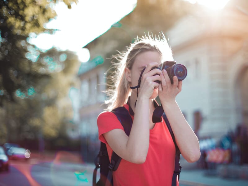 woman taking photo with dslr camera