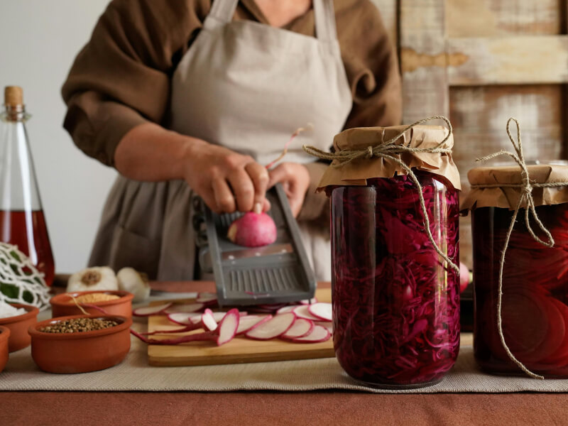 Women grating radish to make pickled vegetables