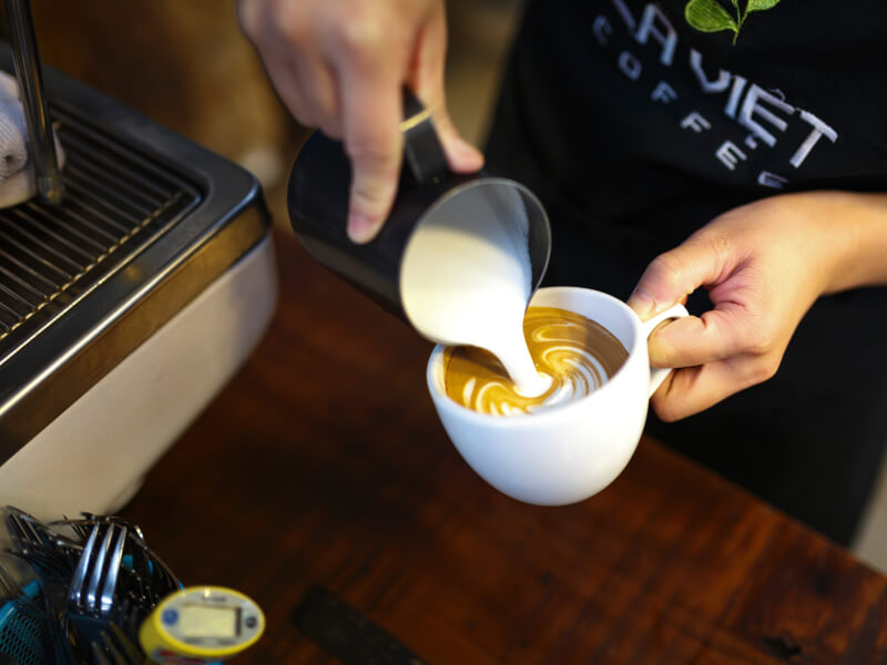 pouring latte art at a barista class in Melbourne
