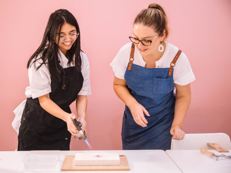 A woman makes poylmer clay earrings with teacher in Perth workshop
