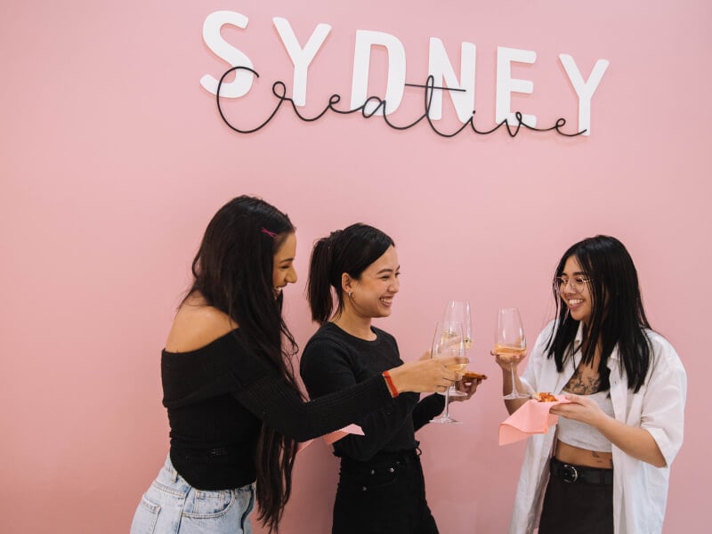Women toasting glasses at a jewellery making class