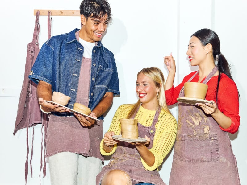 three friends at a pottery class