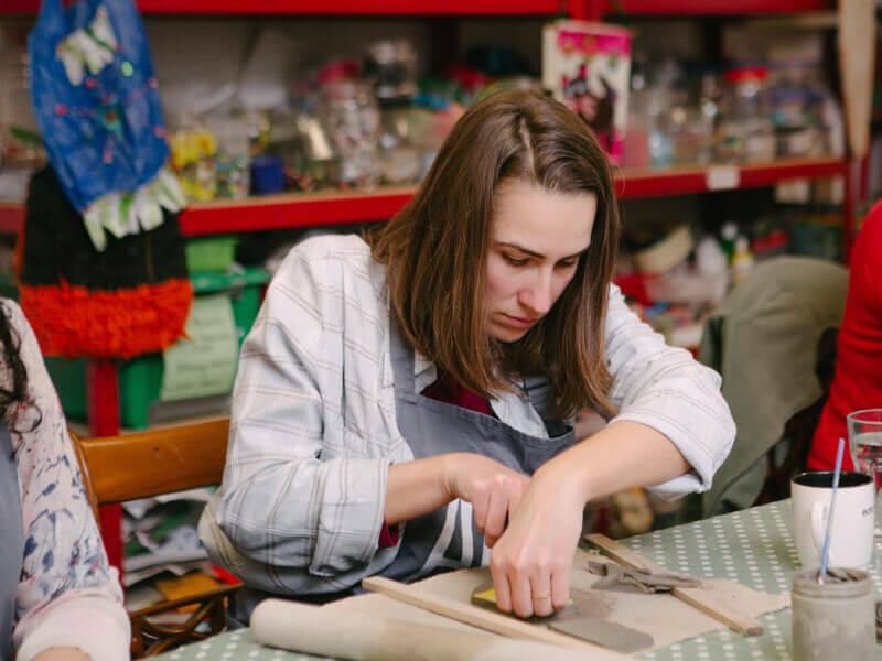A woman in the flow at her pottery class