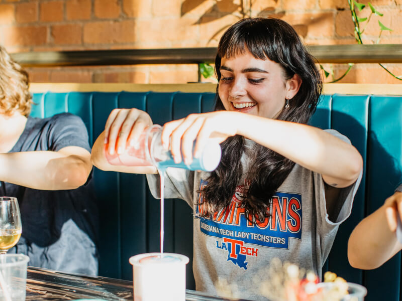 Girl smiling while pouring paints