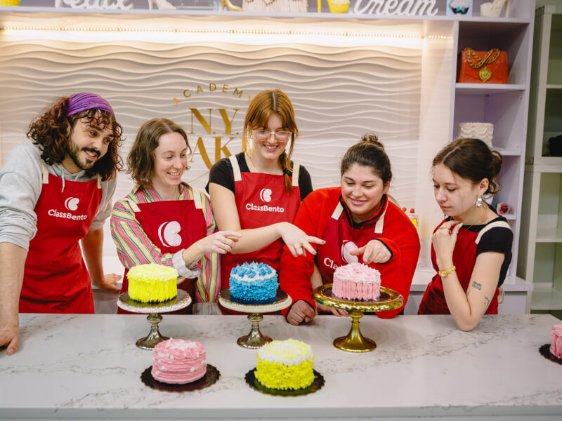 Students show off their hand decorated cakes for dad