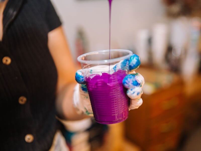 Pretty purple paint being poured for abstract art class
