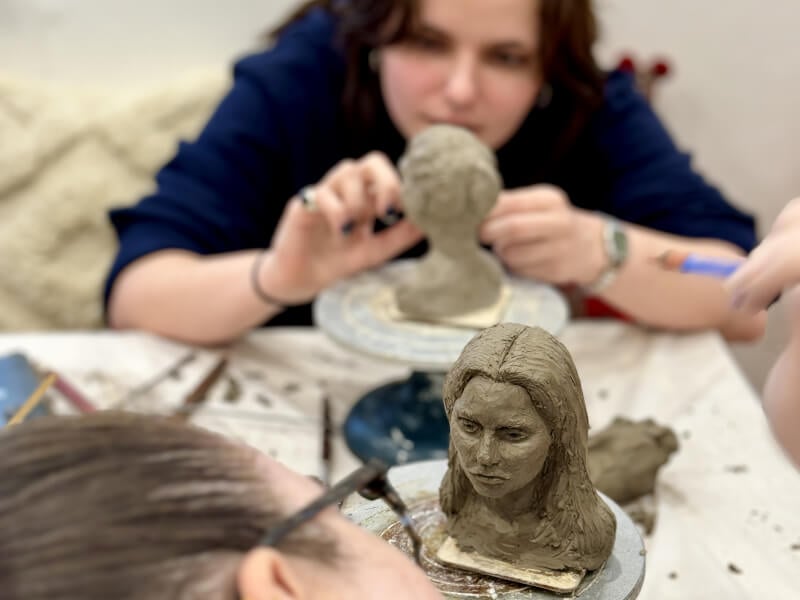 A couple sculpting each other