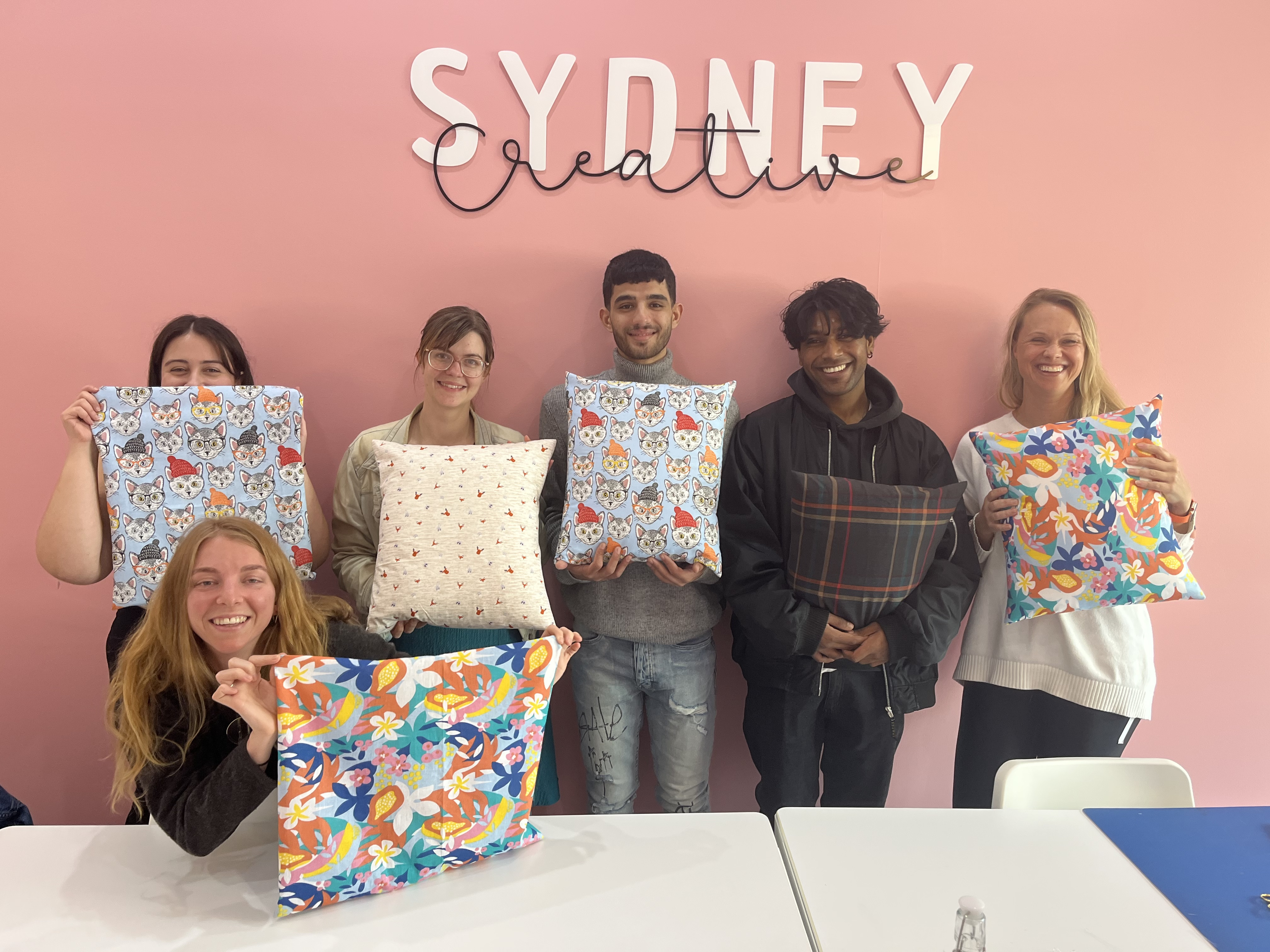 People showing off their DIY cushion covers