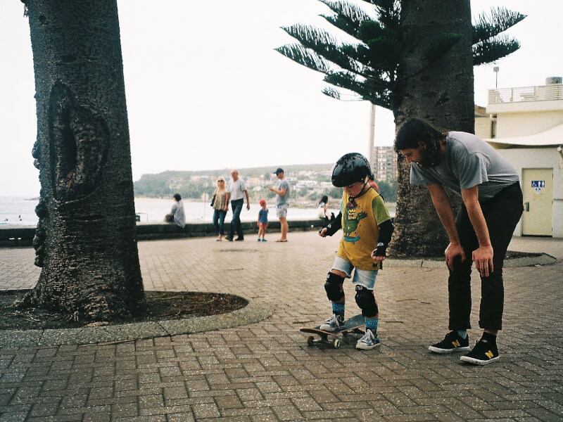 A young boy learns to skate in Manly