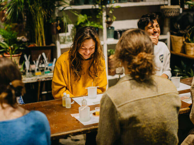 A woman enjoys a candle making class with her boyfriend