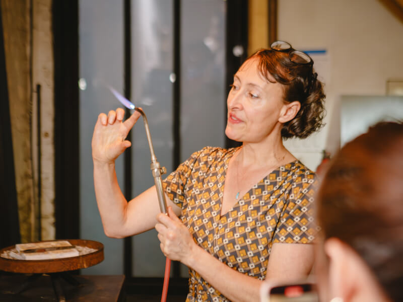 A teacher demonstrating how to solder a ring