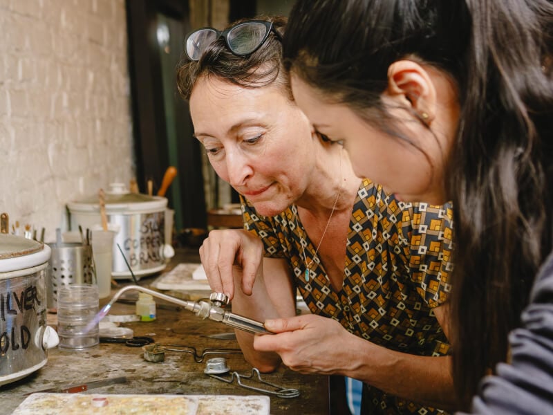 Two women soldering rings