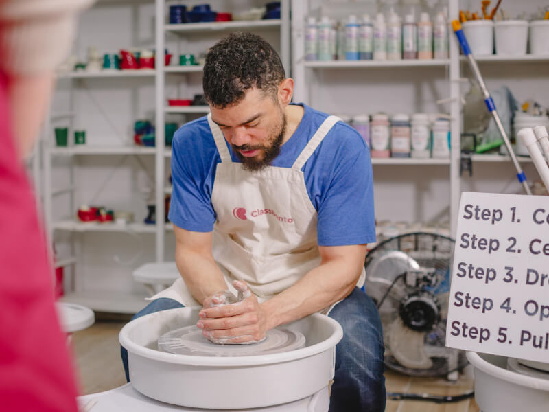 A dad enjoys a wheel throwing class as an experience gift