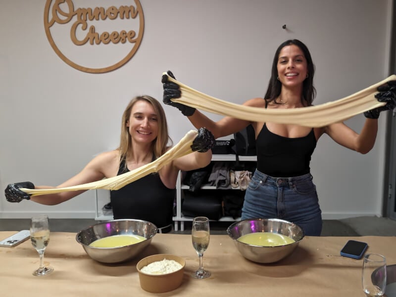 Two women at a cheese making class with bubbles