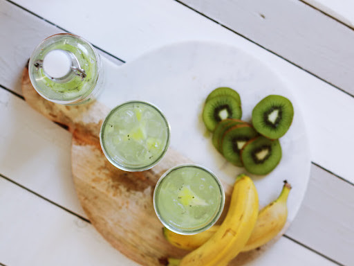 A healthy cocktail set up with fresh fruit and herbs