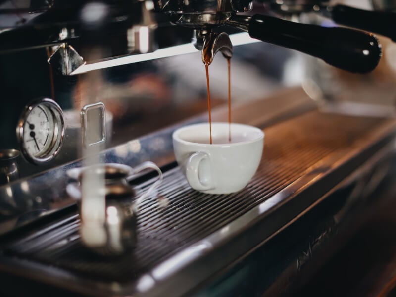 pouring espresso shot at coffee machine
