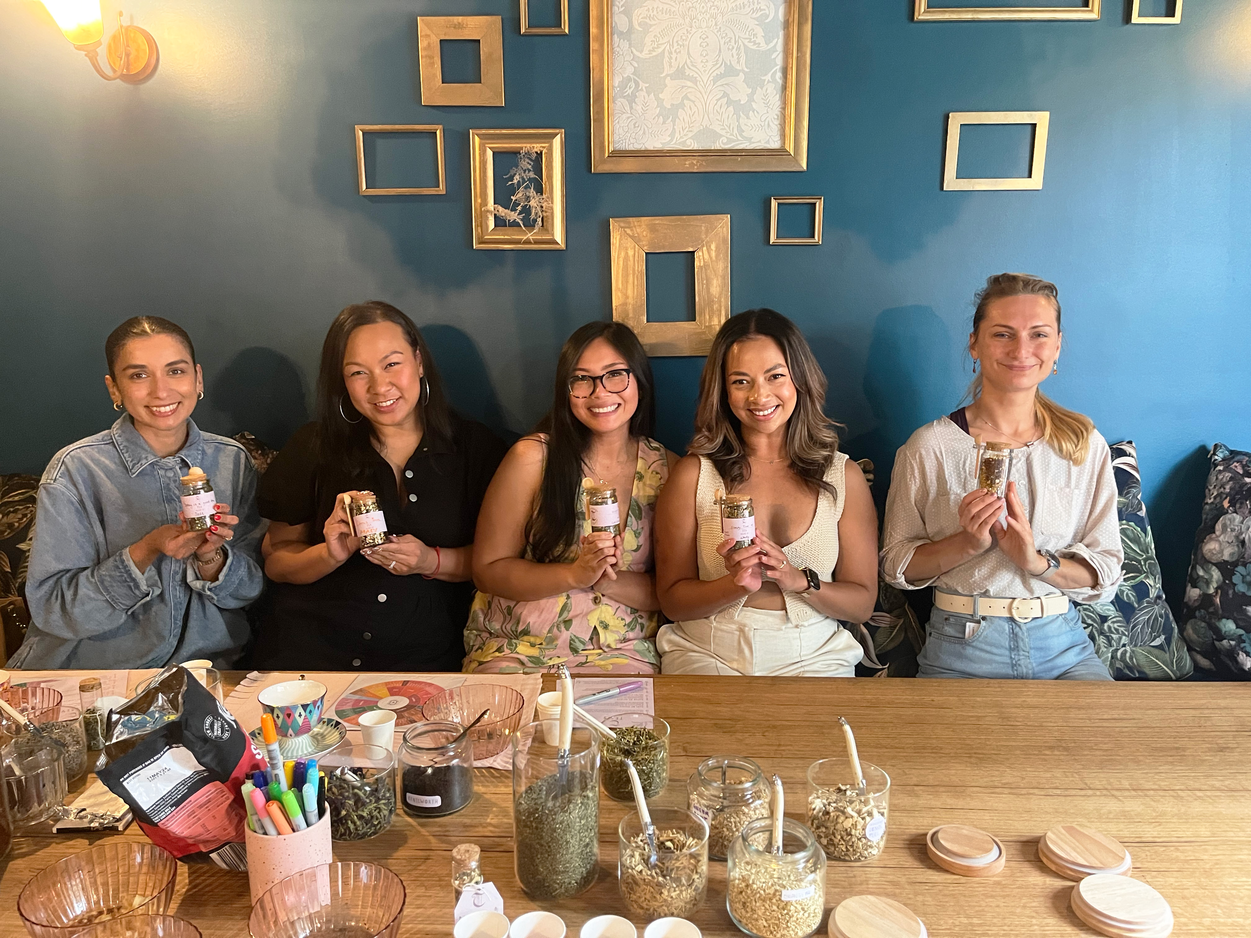 Women showing off their tea blends
