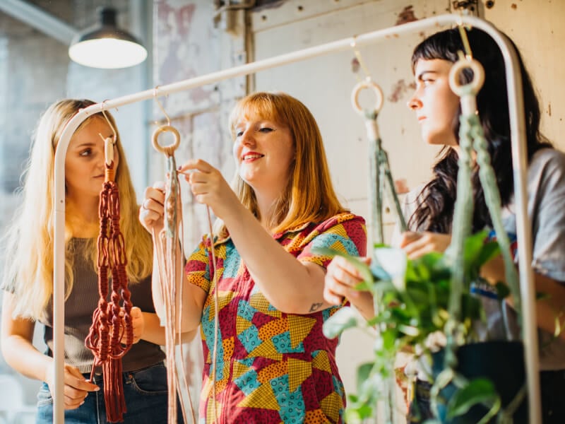 Team members working on textiles at a team building workshop
