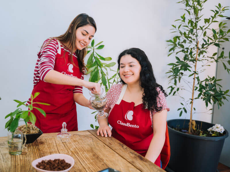 A couple making terrariums on their anniversary at a workshop