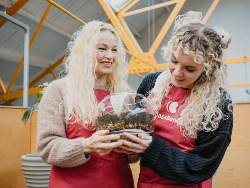 A mother and daughter make terrariums at a creative workshop