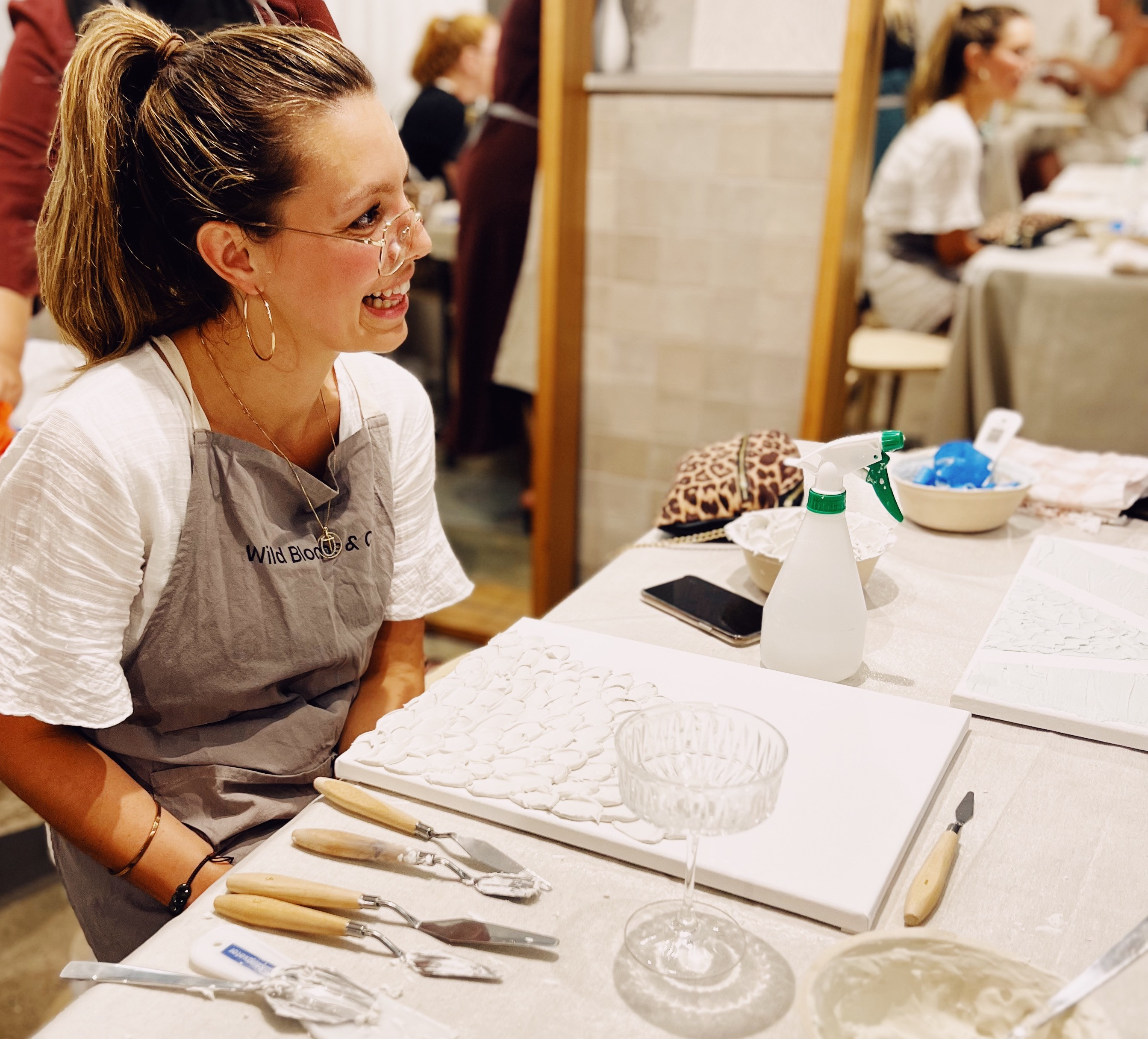 Women smiling in a textured art class
