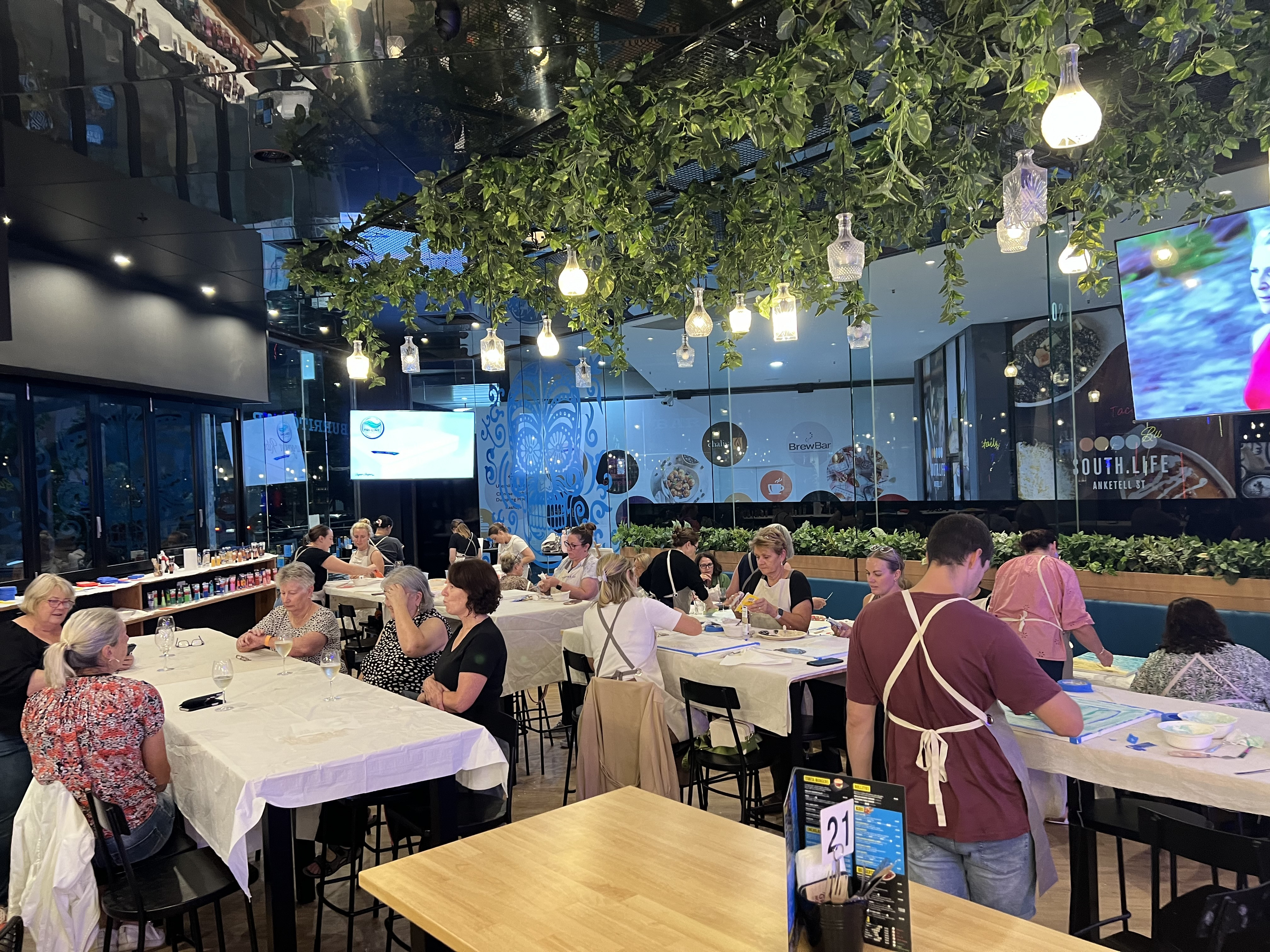 People painting textured art in a restaurant