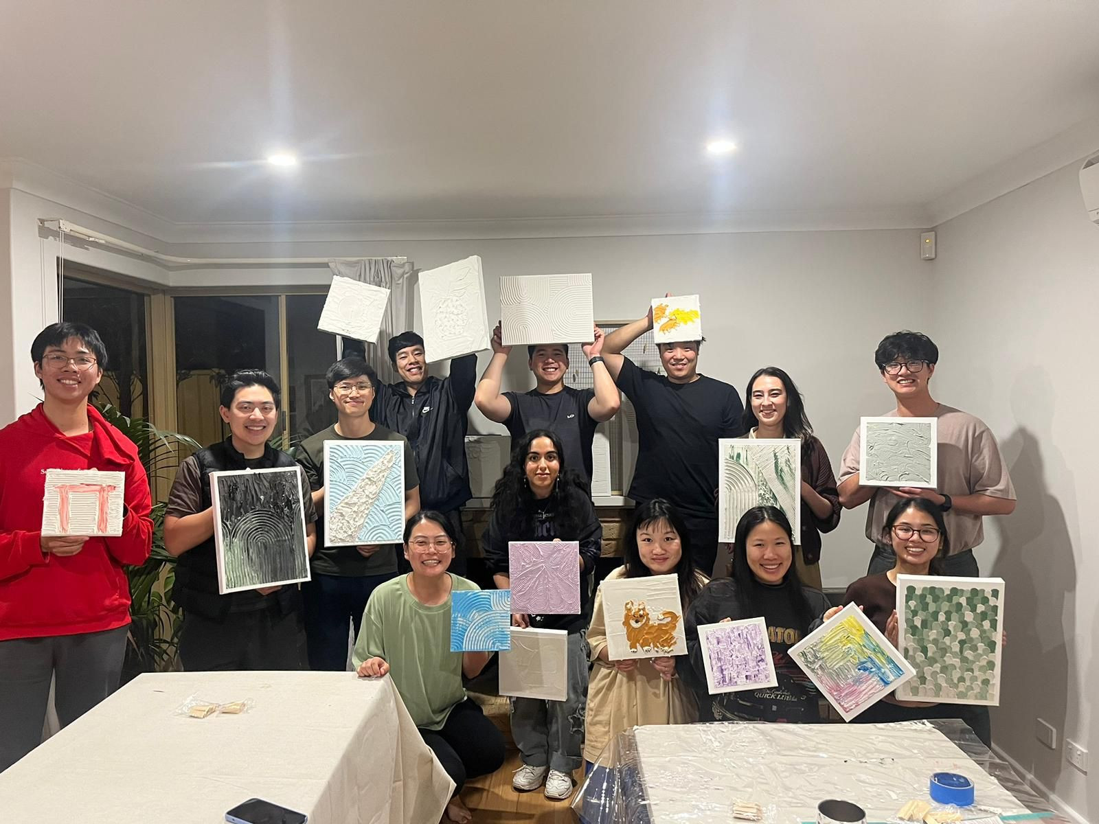 People showing off their textured art pieces