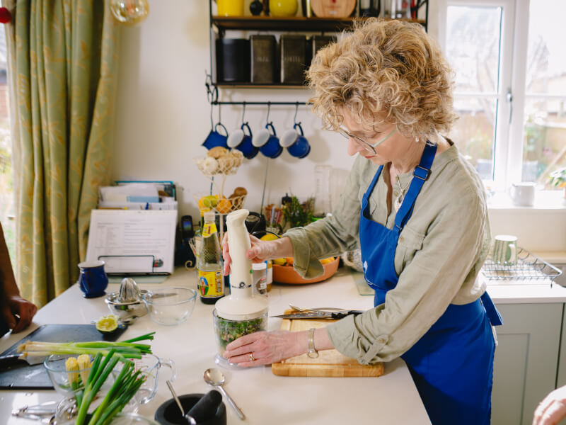 Woman blending ingredients at a Thai cooking class
