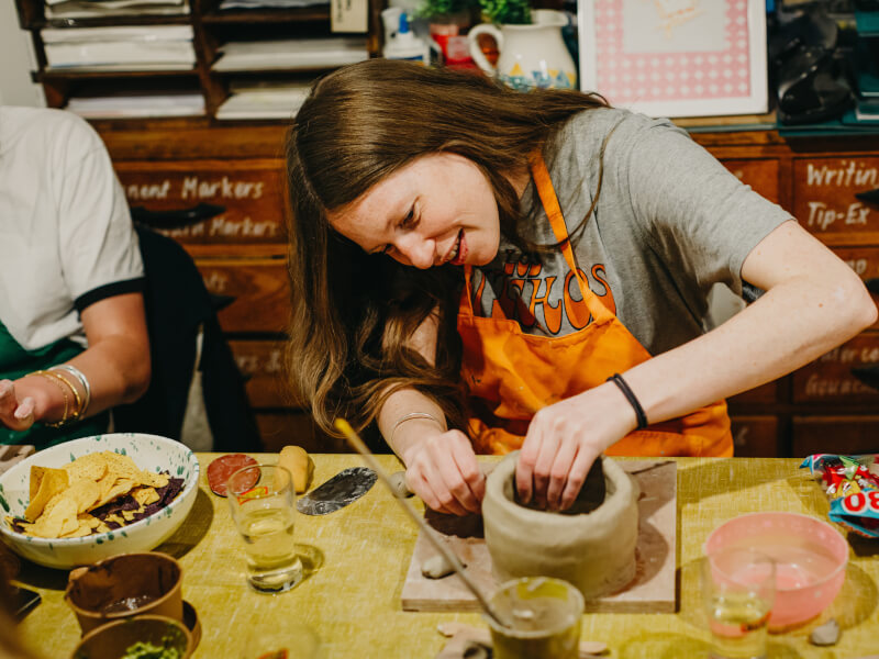 Woman in the process of making bowl at Perth pottery class