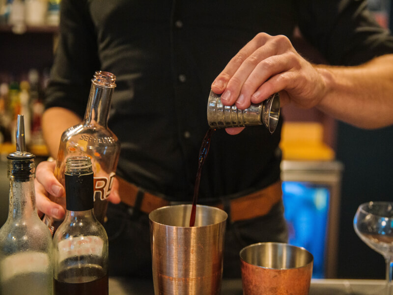 A bartender demonstrating cocktail making