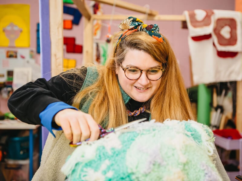 Woman concentrating on her tufting