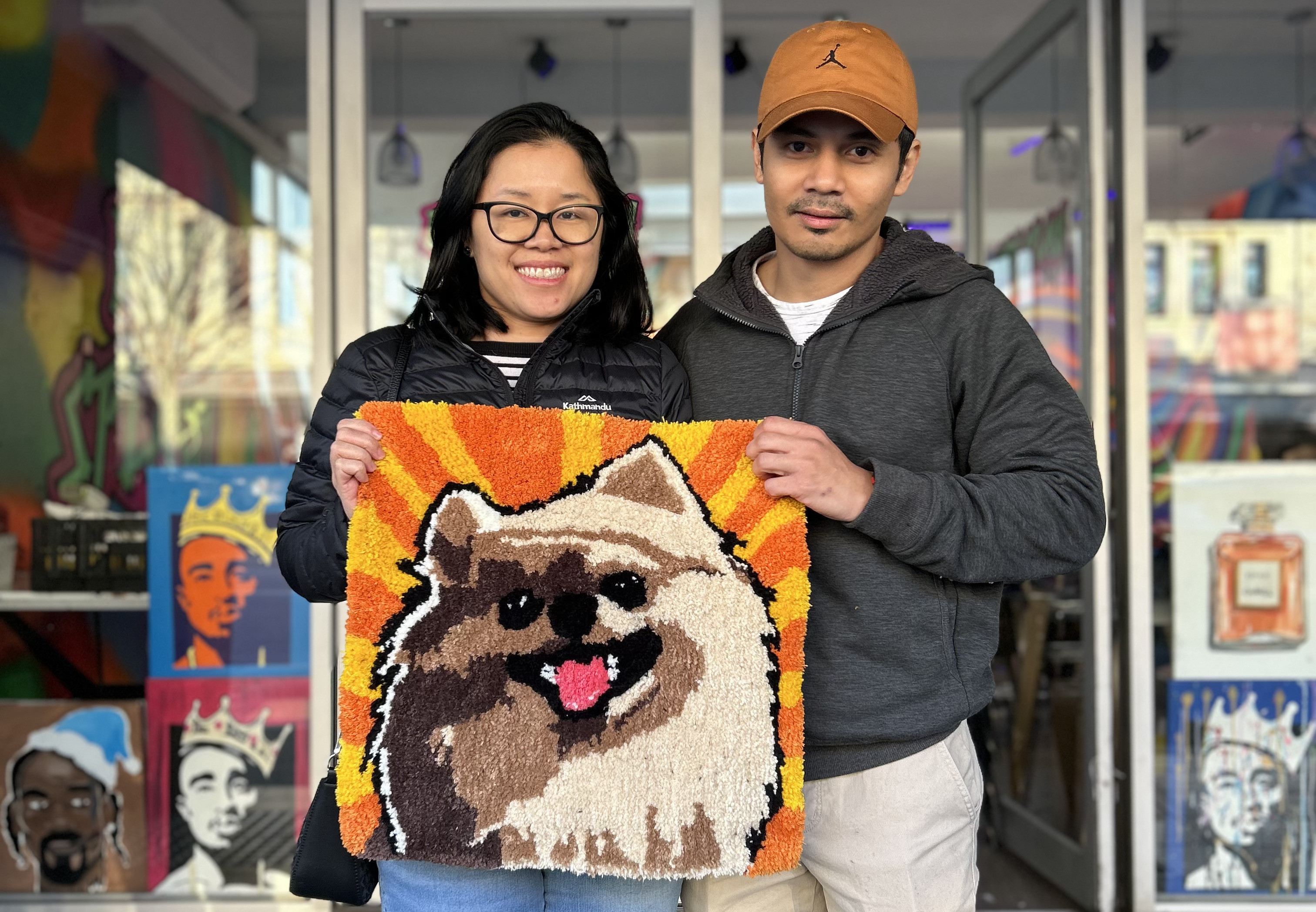 People holding their tufted rug