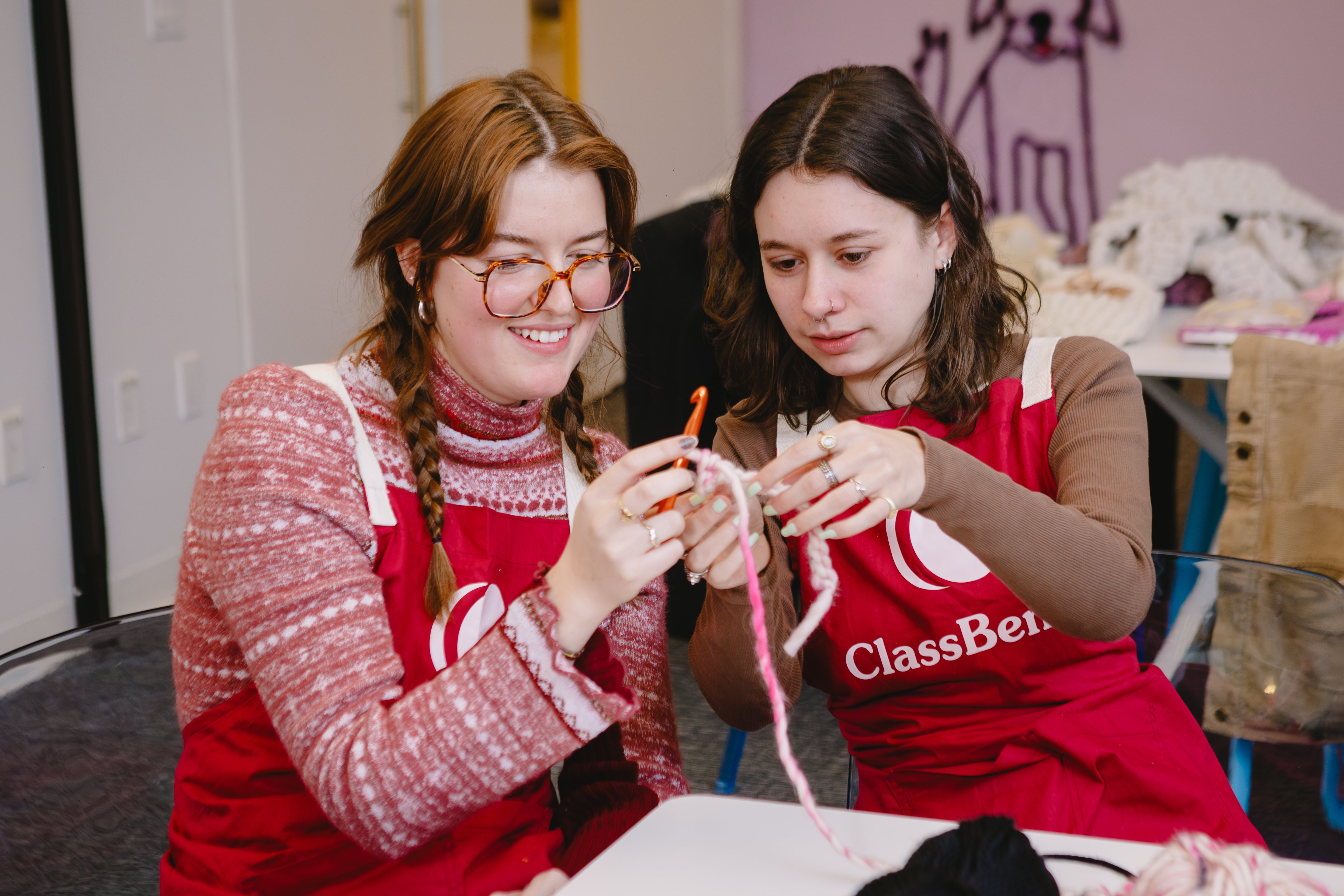 Two friends at an in-person crochet class