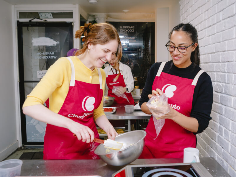 Two friends laughing and baking together