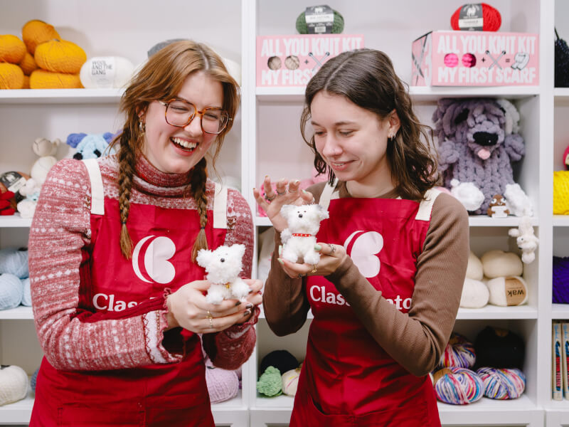 Two girls play with their handmade soft toys