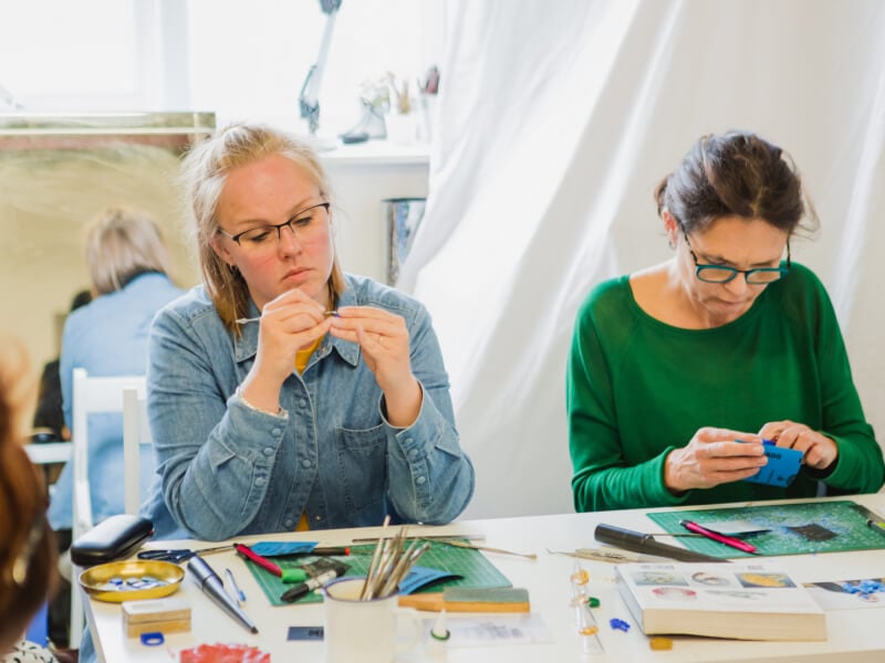 Two women make jewellery at a Mother's Day workshop