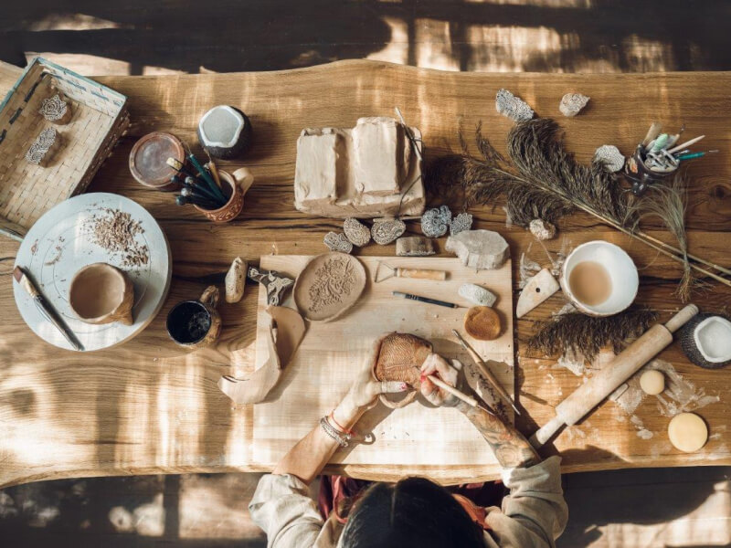 Cosy pottery studio in Adelaide with person working on crafts at desk