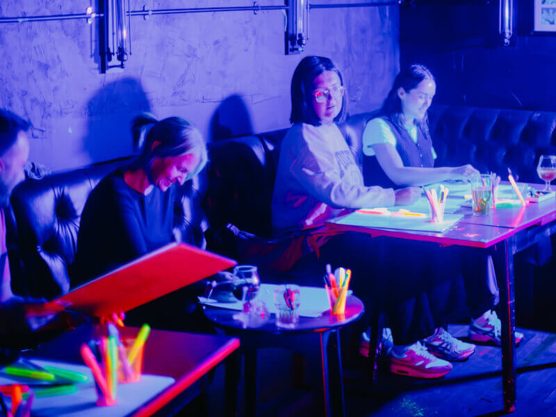 An office team party at a UV paint and sip workshop
