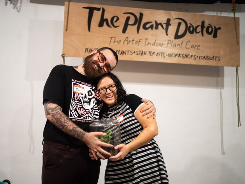 Couple smiling with their terrarium at a terrarium making class in Brisbane